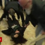 Le Pen protester dragged from news convention